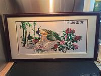 Full framed embroidery showing peacocks, flowers, bamboo and Chinese characters