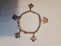 Full view of bracelet showing all five charms and chain