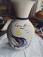 Full view of vase showing Costa Maya sailfish motif and flared rim