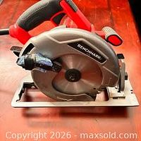 Left side view of Benchmark circular saw showing blade guard, handle and cord