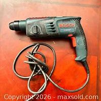 Full view of Bosch corded rotary hammer drill with coiled cord