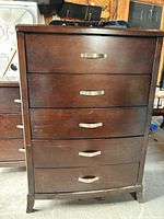 Front view showing five drawers, finish, hardware and feet