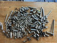 overview of large pile of sockets and accessories on workbench