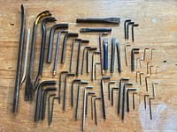 All tools laid out—hex keys, pry bars, chisels