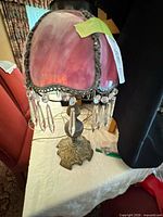 Full lamp showing stained glass shade, prisms, and metal base