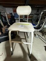 Front view of shower chair showing seat, backrest, armrests