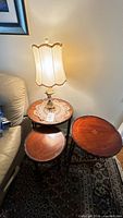 Three round nesting tables with lamp and doily in situ