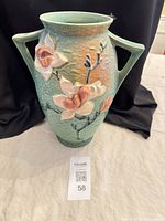 full front view of vase showing color, handles, floral relief