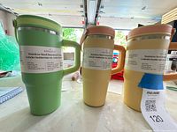 Front view of the three insulated tumblers showing colours, handles and labels
