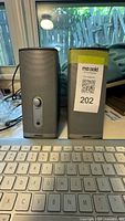 Full view of both Bose speakers beside Apple keyboard