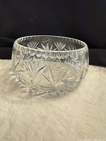 Oblique view of clear cut glass bowl showing starburst and pinwheel cuts