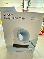 Front of boxed Cricut EasyPress Mini showing product image and branding