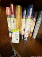 Front view of several glitter vinyl rolls showing colors gold, blue, pink, silver