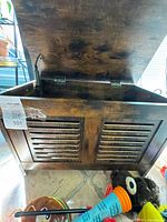 Bench with lid open showing interior and slatted front