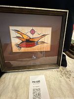 Full framed lithograph on display showing frame and mat