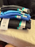 Stack of eight folded Gildan XL T-shirts with size bands visible