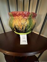 Front view of multi-color majolica planter on shelf
