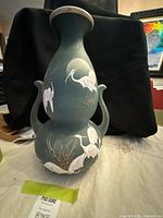 Full view of ceramic vase front showing bird motif and handles