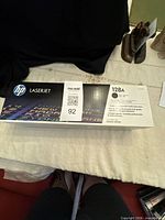 Front view of sealed HP 128A toner cartridge box