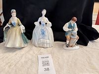 All three figurines shown together for scale and grouping