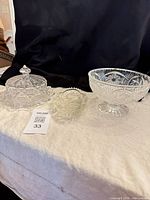 Group shot showing all three glass pieces: footed compote, covered dish, relish tray