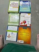 All six paperback workbooks laid out