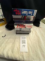 Stack of seven audiobook cases showing Tom Clancy, Michael Crichton and John Grisham titles