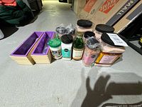 Group view of salts, coconut oil, glass oil bottle and two bamboo moulds