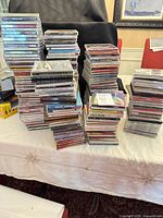 Multiple stacks of jewel case CDs on table