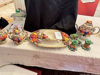 Group shot of entire ceramic fruit motif set on table