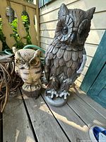 Both resin owl statues side by side on deck