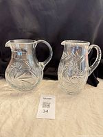 Both crystal pitchers side by side front view