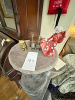 group shot showing porcelain figurine, brass owl, two glass vases, brass trinket box