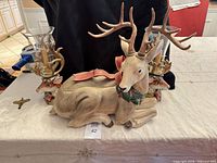 overall view of reindeer planter and pair of candle holders with hurricanes