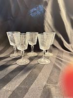 Front view of five cut crystal cordial glasses