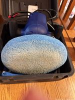 Blue Simoniz polisher with blue bonnet inside black case