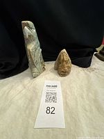 Front view of both soapstone carvings showing eagle and human head