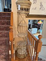Full view of tall spiral etagere on stair landing