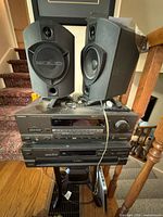 Stacked Technics receiver and CD changer with two Solid bookshelf speakers on top