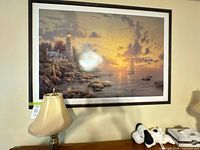 Front view of framed Thomas Kinkade lithograph on wall
