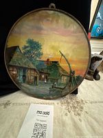 Full view of round plaque showing entire rural waterfront scene and frame
