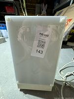 Front view of white plastic light box lamp