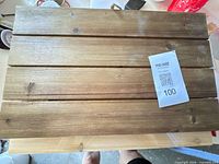 Brown stained wood slat panel, QR tag #100 visible