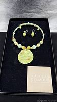 Full set in presentation box showing necklace, earrings, card