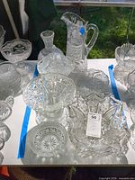 Group view showing major pieces: pitcher, covered compote, pedestal bowl, oval bowl, small bowls
