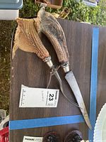 Knife and fork showing antler handles, blades, sterling ferrules