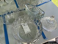 Assorted clear cut and pressed glass bowls and candy dish overview