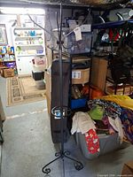 Full view of black metal coat rack in storage space