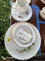 Stack showing pitcher, saucer, plates and bowls