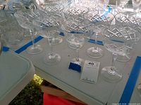 Group of six crystal coupes on table, showing diamond crosshatch pattern and overall condition